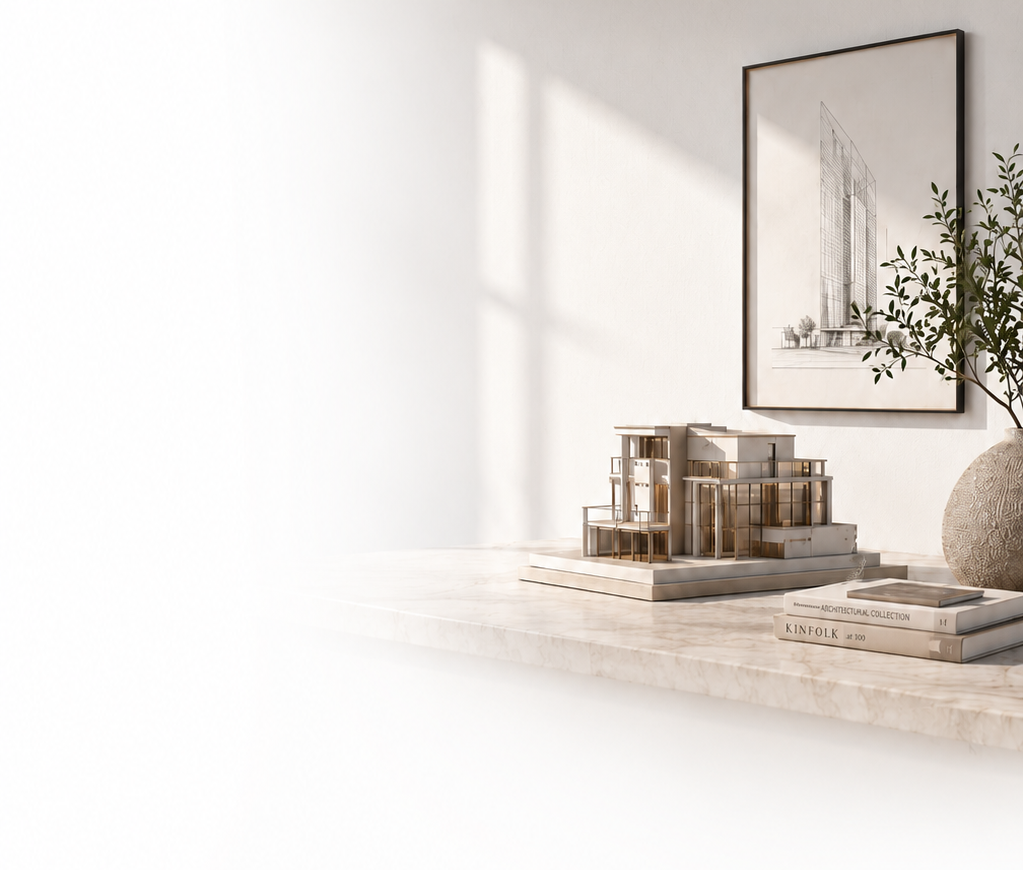 Architectural model on a marble table beneath a framed building sketch